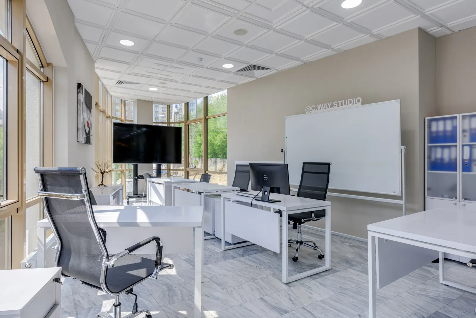 Spacious and bright modern office interior with sleek furniture, ideal for professional workspaces