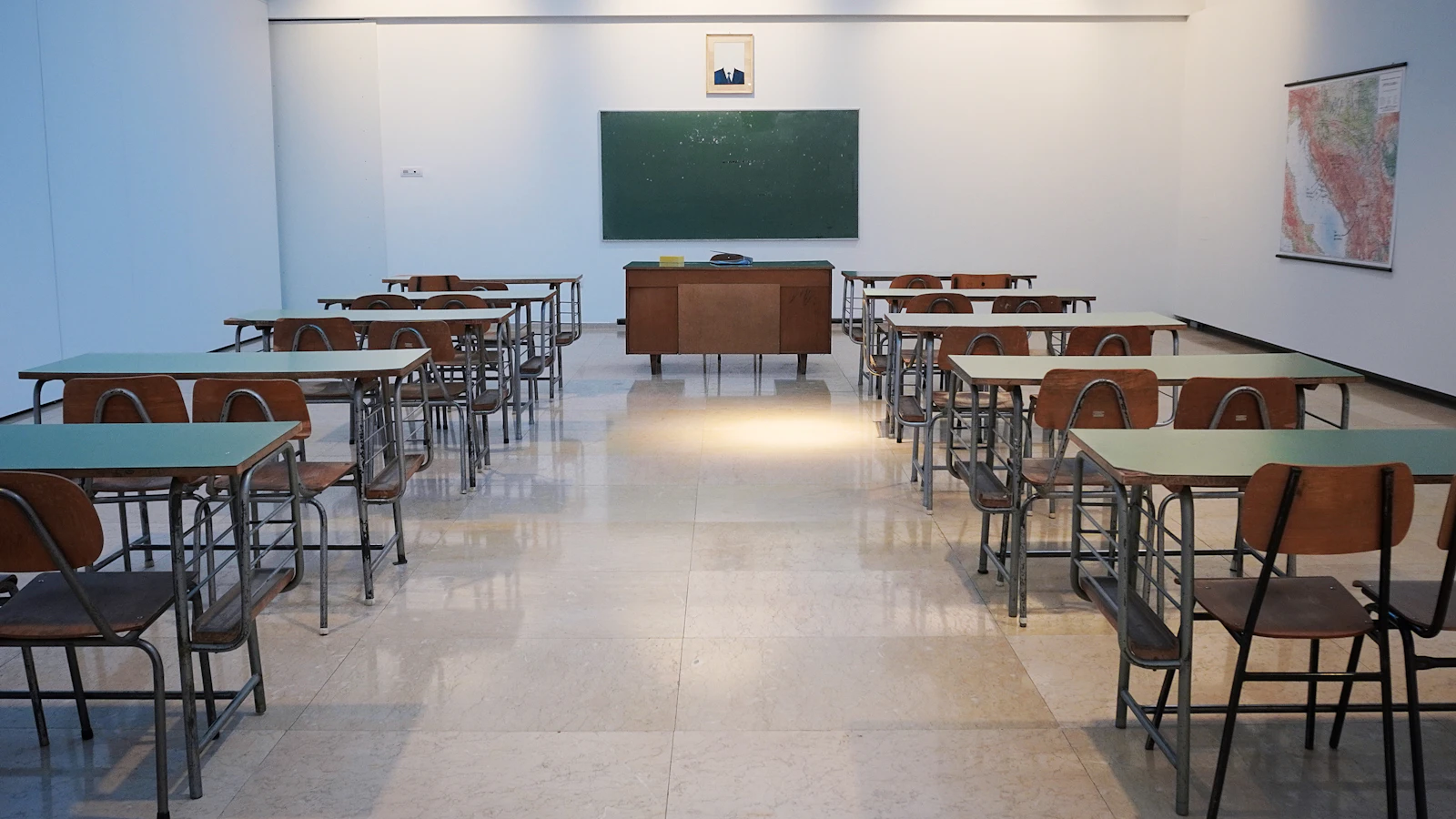 Empty classroom with desks and chalkboard