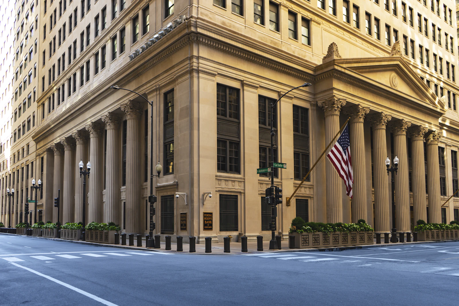 A large building with columns and a flag on the corner