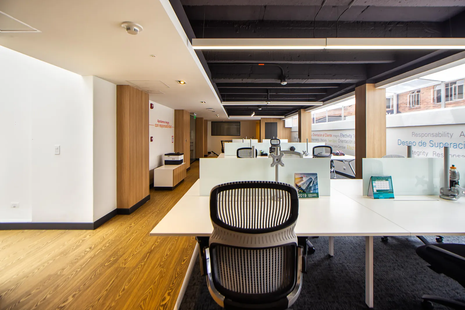 Spacious and well-lit modern open plan office with minimalist design and sleek furniture