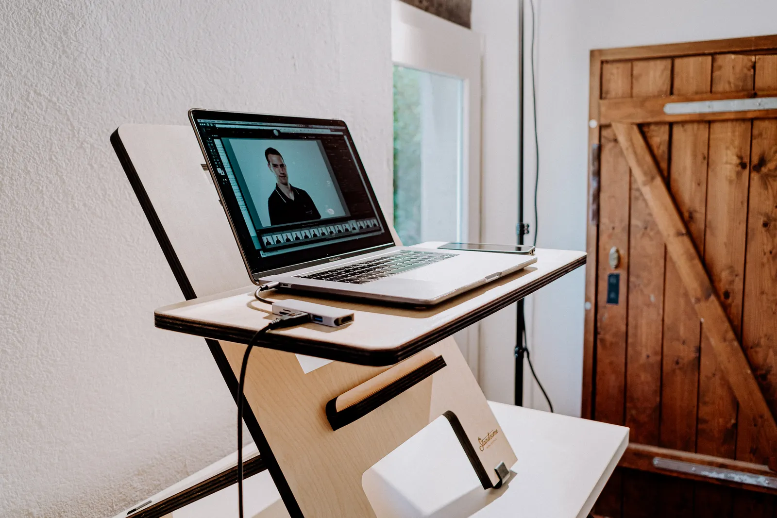 A modern workspace featuring a laptop on a sleek wooden desk, perfect for home or office settings