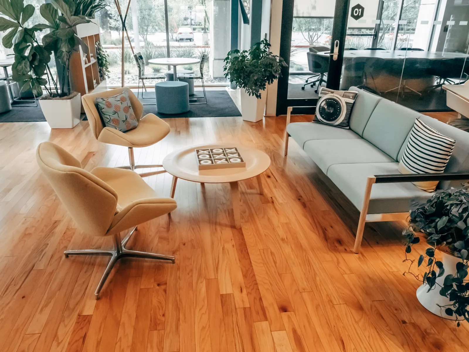 A bright and inviting office lounge with contemporary furniture and wooden flooring